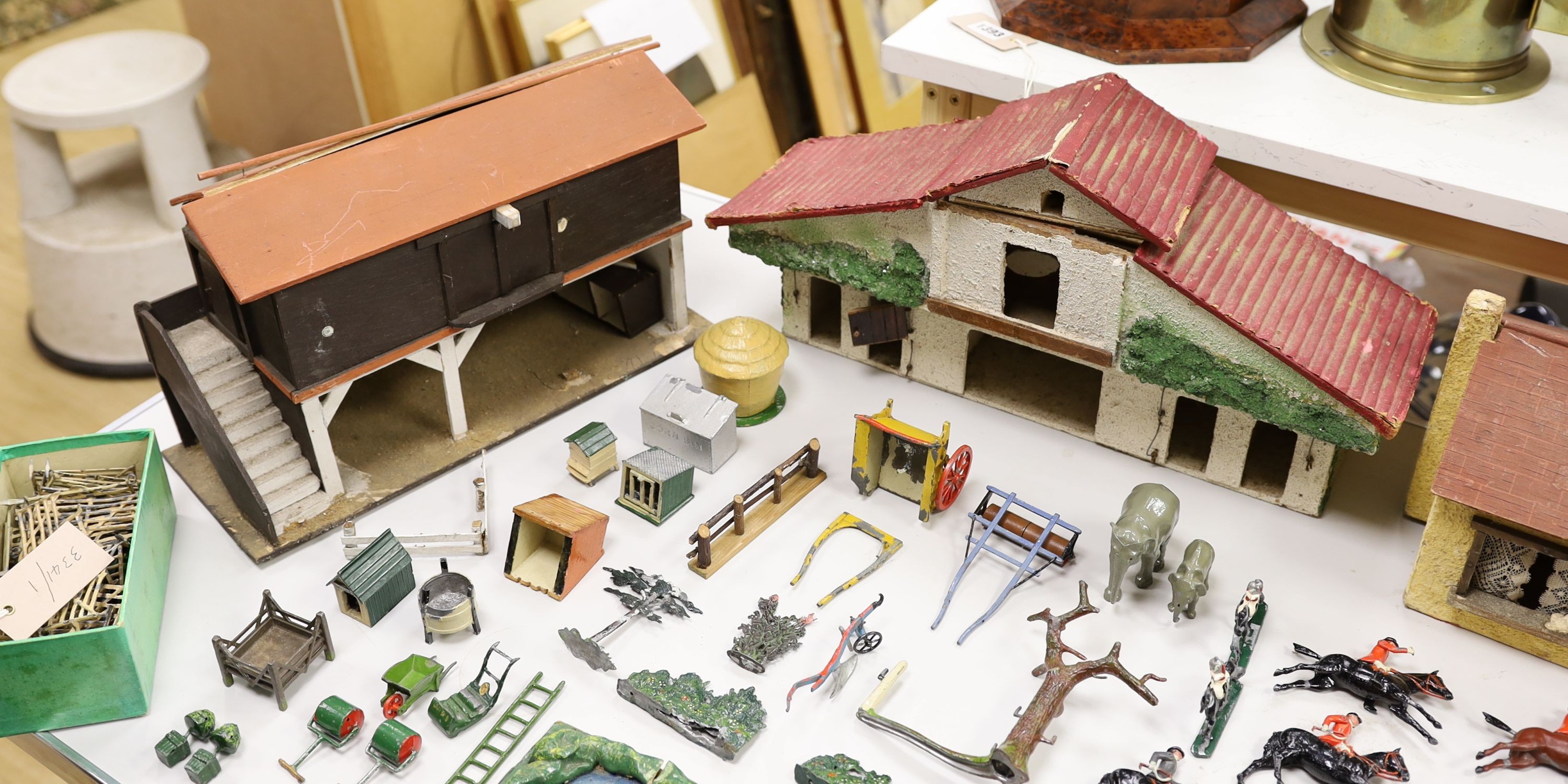 A collection of mainly Britains painted lead figures and animals, including huntsmen and hounds, farm workers, animals and wooden buildings